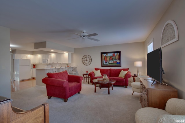 carpeted living room with ceiling fan