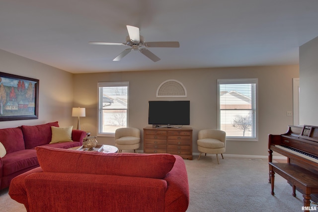 carpeted living room with ceiling fan