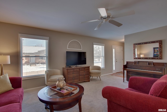 carpeted living room featuring ceiling fan and a healthy amount of sunlight