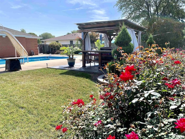 view of yard featuring a fenced in pool, fence, and a patio