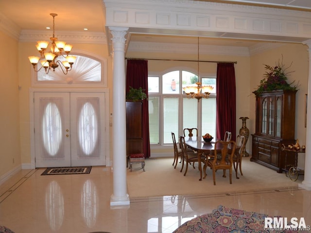 foyer featuring decorative columns, crown molding, a notable chandelier, and french doors