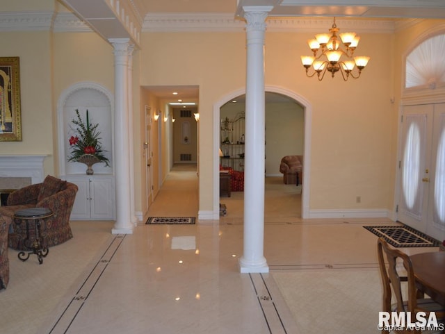 foyer featuring decorative columns, visible vents, a towering ceiling, ornamental molding, and baseboards