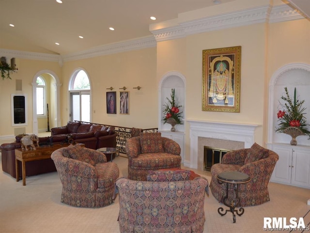 carpeted living area featuring high vaulted ceiling, recessed lighting, ornamental molding, and a glass covered fireplace