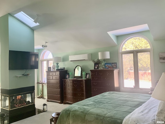 carpeted bedroom with a skylight, a multi sided fireplace, and a wall mounted AC