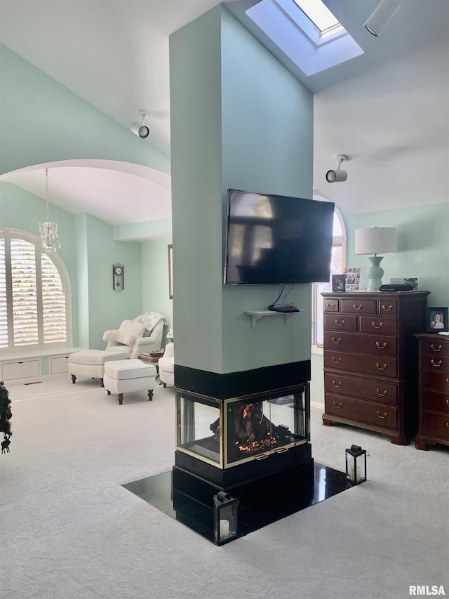 living room with carpet, lofted ceiling, and a multi sided fireplace