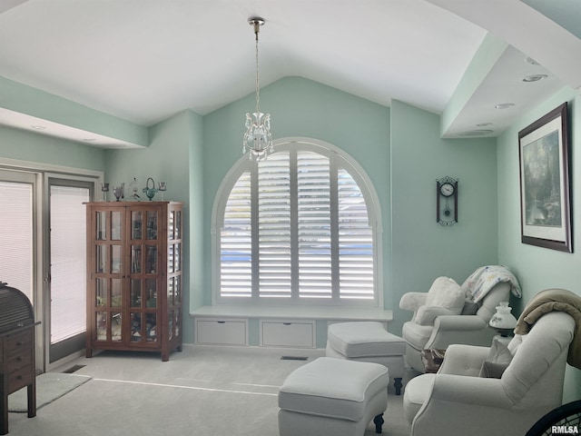 living area with vaulted ceiling, carpet flooring, and a notable chandelier