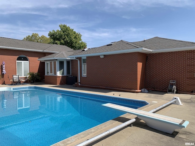 outdoor pool with a patio area