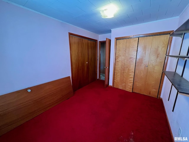 unfurnished bedroom featuring a closet, carpet, and ornamental molding