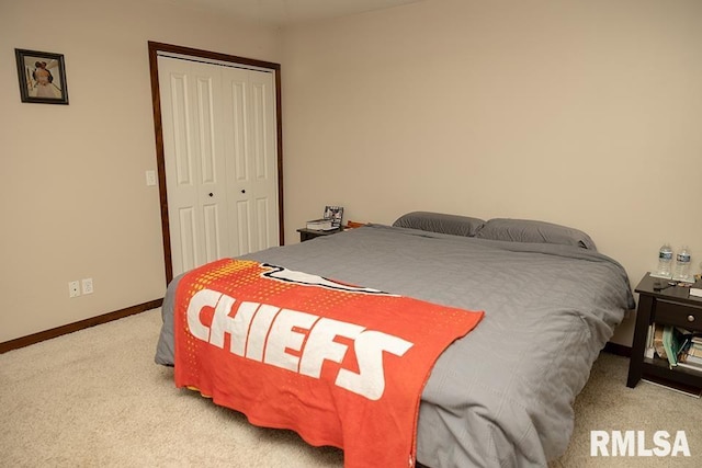 bedroom featuring light colored carpet and a closet