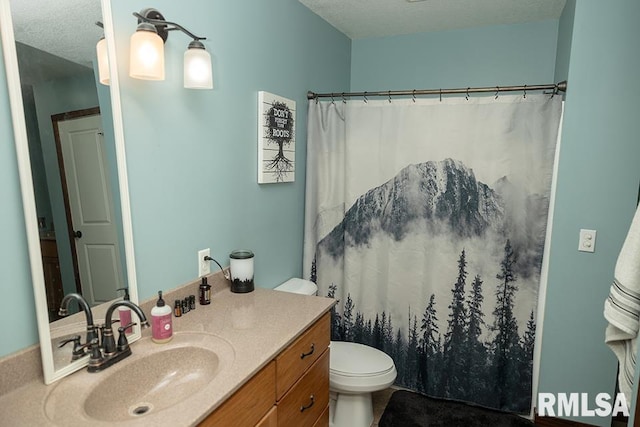 bathroom featuring toilet, vanity, a textured ceiling, and curtained shower