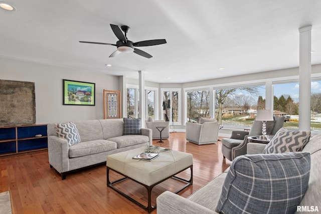 living room featuring light hardwood / wood-style floors and ceiling fan