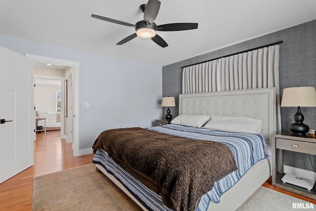 bedroom with hardwood / wood-style flooring and ceiling fan