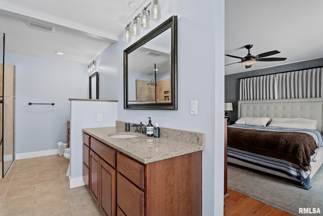 bathroom with ceiling fan, vanity, toilet, and tile patterned flooring