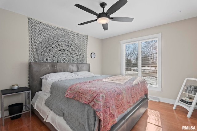 bedroom with wood-type flooring and ceiling fan