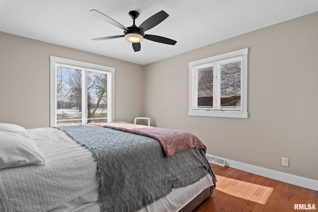 bedroom with hardwood / wood-style floors and ceiling fan