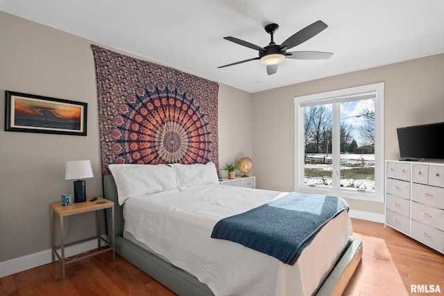 bedroom with light hardwood / wood-style floors and ceiling fan