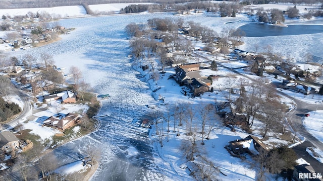 snowy aerial view with a water view