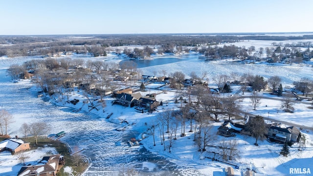 snowy aerial view featuring a water view