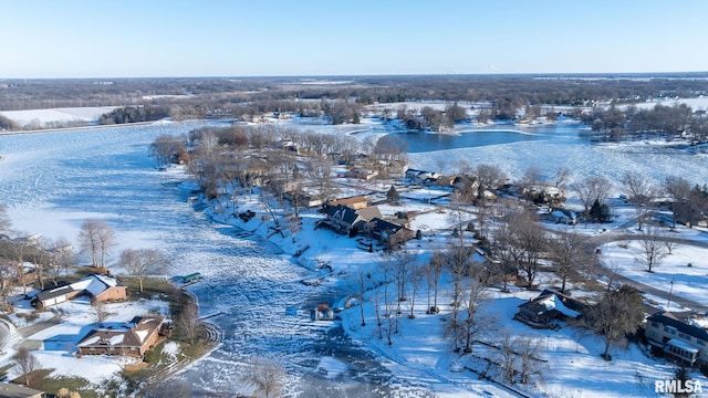 snowy aerial view with a water view