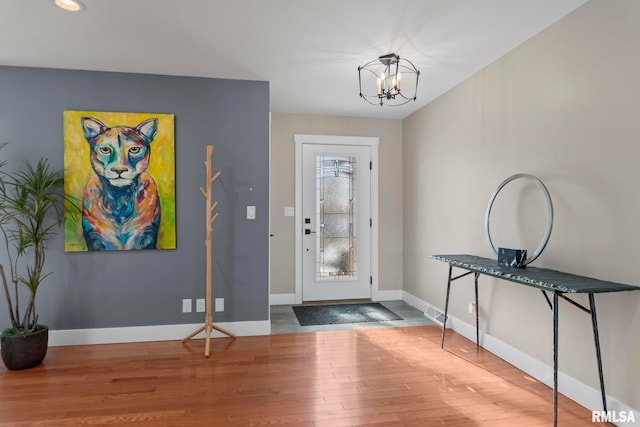 entryway with an inviting chandelier and hardwood / wood-style floors