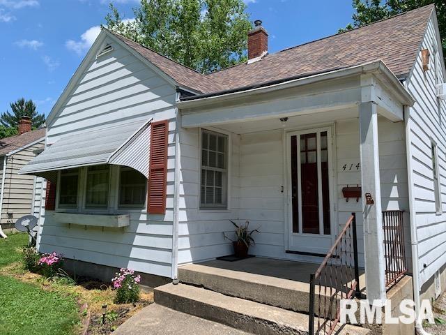 bungalow with a porch, a chimney, and a shingled roof