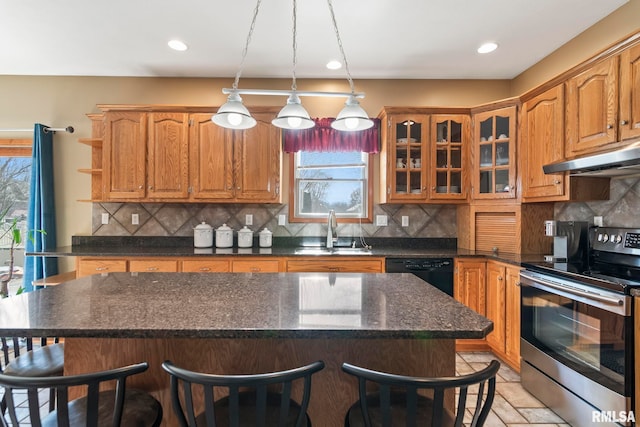 kitchen with a center island, stainless steel range with electric cooktop, a sink, and under cabinet range hood