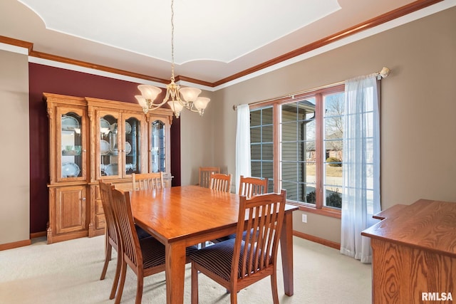 dining area featuring light carpet, baseboards, a chandelier, and crown molding