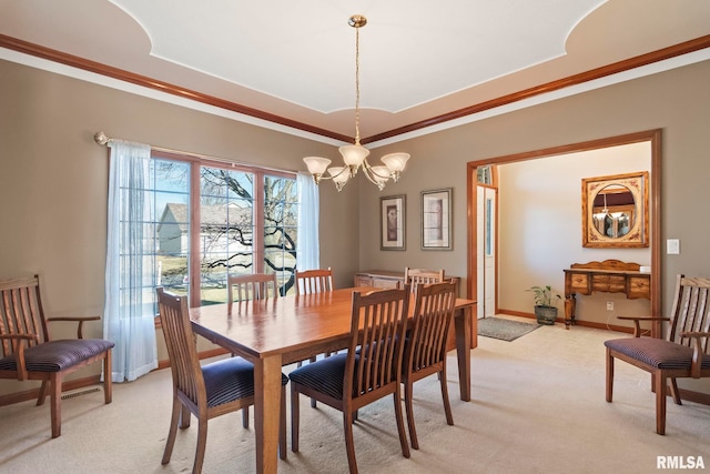 dining space featuring light carpet, baseboards, a tray ceiling, crown molding, and a chandelier