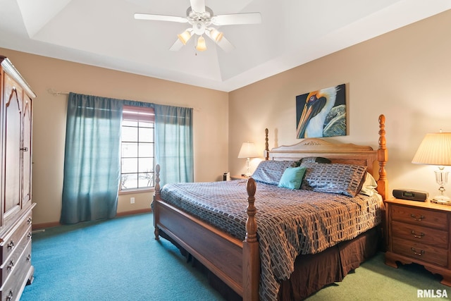 bedroom featuring carpet flooring, a raised ceiling, a ceiling fan, and baseboards