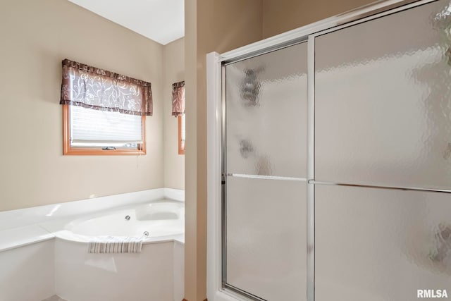 full bathroom featuring a stall shower and a bath