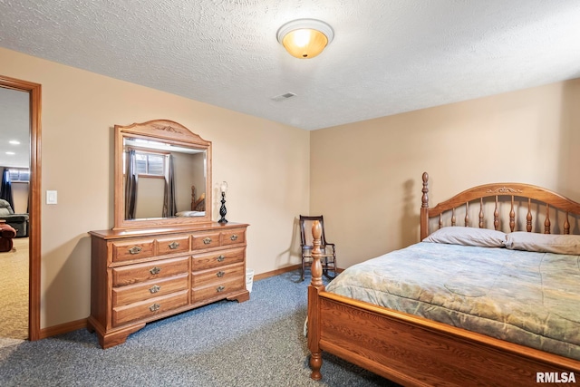 carpeted bedroom with a textured ceiling, visible vents, and baseboards