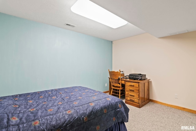 bedroom with light carpet, visible vents, and baseboards