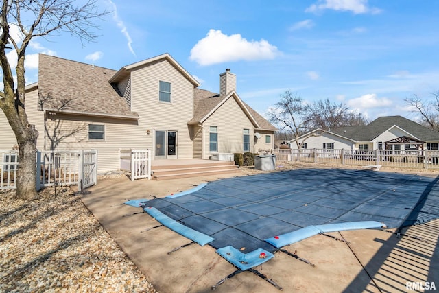 view of swimming pool with a fenced in pool, a patio area, fence, a deck, and a diving board