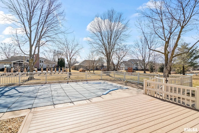 wooden terrace with a patio, fence, and a residential view