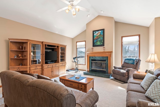 living room featuring a ceiling fan, light colored carpet, a fireplace, and high vaulted ceiling