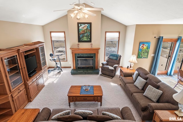 living room with a ceiling fan, light colored carpet, plenty of natural light, and a premium fireplace