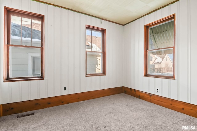 carpeted empty room with ornamental molding