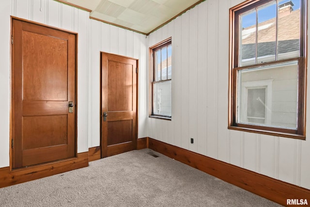 carpeted empty room with crown molding