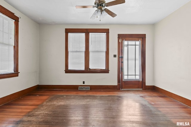 interior space with ceiling fan and dark wood-type flooring