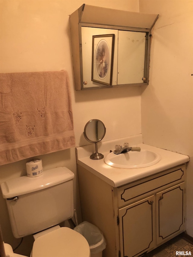 bathroom with toilet and vanity