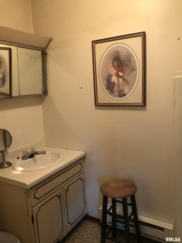 bathroom with vanity and baseboard heating