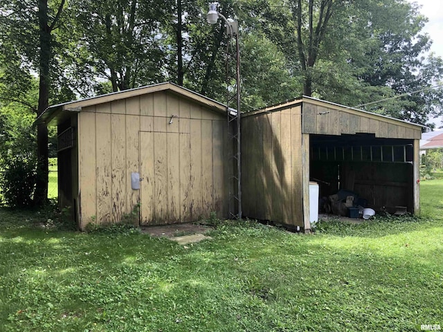 view of outbuilding featuring a lawn