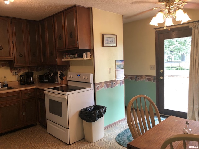 kitchen featuring electric range, dark brown cabinets, sink, and a textured ceiling