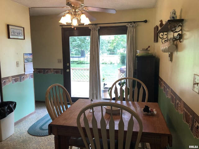 dining space with a textured ceiling and ceiling fan