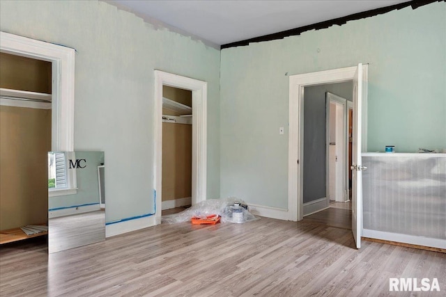 unfurnished bedroom with light wood-type flooring