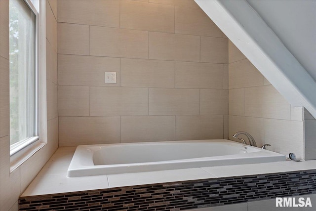 bathroom with tiled bath