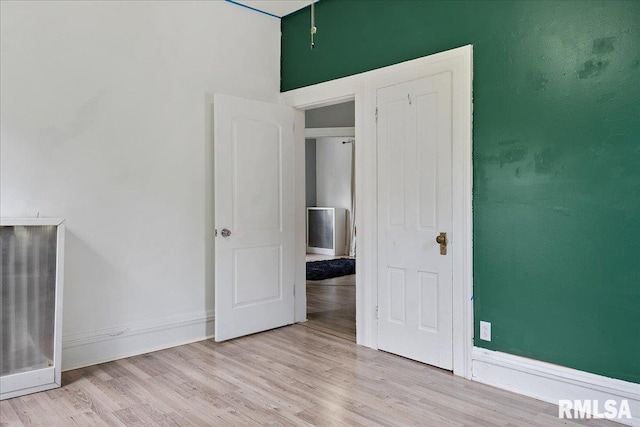 unfurnished bedroom featuring light wood-type flooring