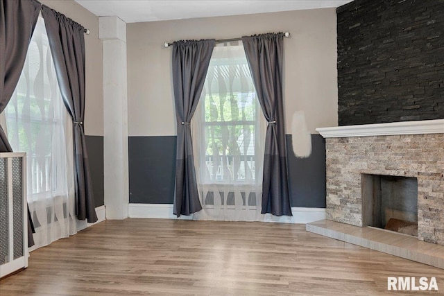 unfurnished living room with a fireplace and wood-type flooring