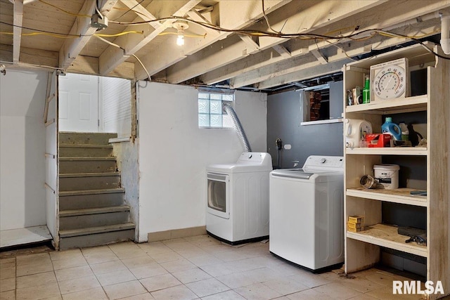 laundry area featuring tile patterned flooring and washing machine and clothes dryer