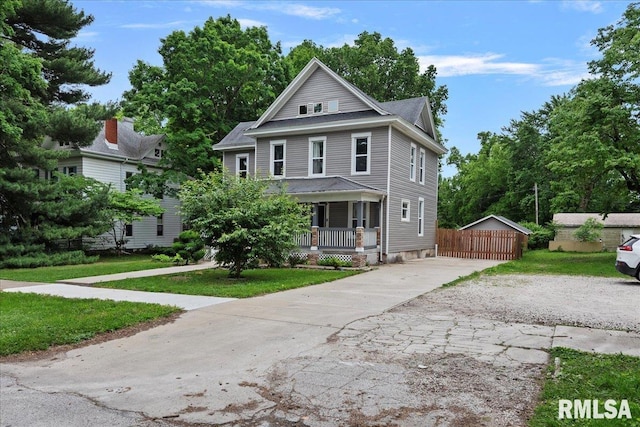 view of front of property with covered porch and a front yard